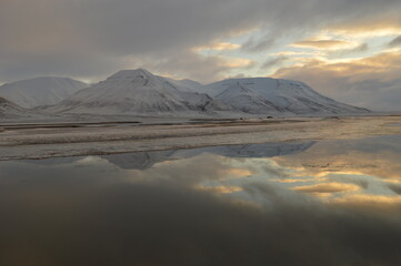 Sunset reflections over the frozen Arctic Norwegian Archepelago of Svalbard, Norway