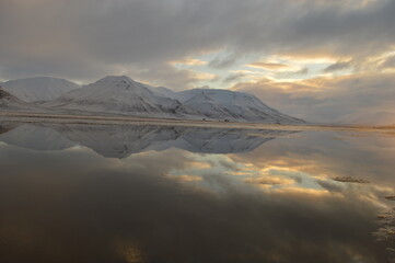 Sunset reflections over the frozen Arctic Norwegian Archepelago of Svalbard, Norway