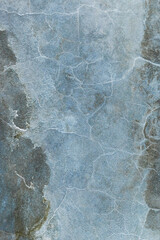 Abstract blue background. Cracks. The texture of the old surface. Cracks in the old plaster. Old texture. Grunge texture. Blue grunge background.