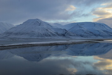 Fototapeta na wymiar Sunset reflections over the frozen Arctic Norwegian Archepelago of Svalbard, Norway
