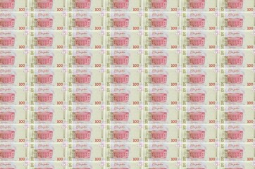 100 Ukrainian hryvnias bills printed in money production conveyor. Collage of many bills. Concept...