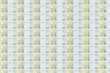 20 Thai Baht bills printed in money production conveyor. Collage of many bills. Concept of currency...