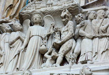 Fototapeta na wymiar Architectural detail of 'Judgement day' on the facade of Notre Dame Cathedral