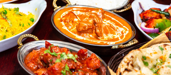 Fototapeta na wymiar assorted indian curry and rice dishes .Indian food shot from top view.