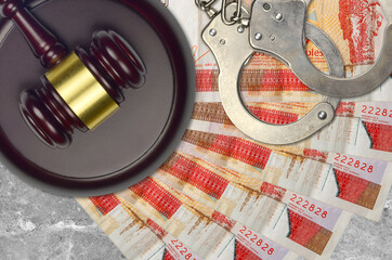 3 cuban pesos convertibles bills and judge hammer with police handcuffs on court desk. Concept of...