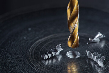 metal drill bit make holes in steel billet on industrial drilling machine. Metal work industry....