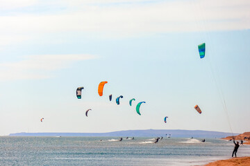 a kitesurfer surfing on the smooth azure water. recreational sport. A Man Rides A Kiteboarding In The Sea Water. extreme sport. Jump