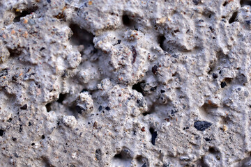Gray cracked wall of old cinder block close up