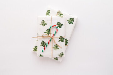 Christmas composition. Gifts, red and green Christmas candy, decorations on a white background. The concept of Christmas, winter, New year. Flat stacking, top view, copy space.