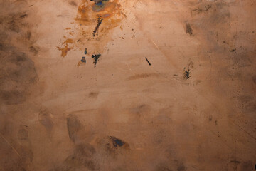 Scratched copper surface with fingerprints and stains.