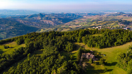 Aerial landscape from the drone of italian Appennini mountains, with trees, meadows and fields