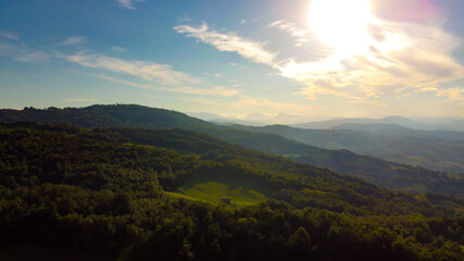 Aerial landscape from the drone of italian Appennini mountains, with trees, meadows and fields
