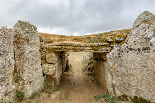 Dolmen La Cabana with cloudy sky in Sargentes de Lora, Burgos, Castilla y Leon, Spain
