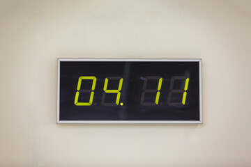Black digital clock on a white background showing time 04 11