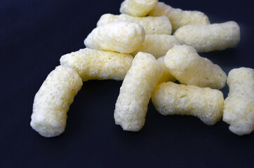 Corn sticks on a dark background.