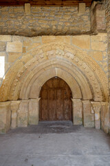 Fototapeta na wymiar Door of the Hoyos del Tozo church, with Romanesque elements, in Burgos, Castilla y Leon, Spain