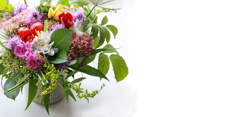 Bouquet of garden flowers in a ceramic Cup on a white background. Flowers as a gift for a woman. Banner with a bouquet.