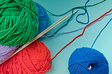 Group of various yarn balls and knitting needles closeup