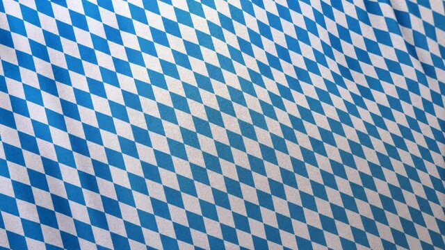 Full frame Bavarian blue white German Munich Oktoberfest pattern concept template. Cloth fabric waving 3D animation. Seamlessly looping copy text background with Bavaria State flag fabric table cloth.