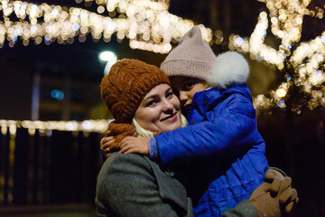 Magic on streets of the old town at Christmas. happy young mother and daughter at Christmas