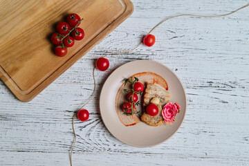pork steak, grilled and served with cherry tomatoes on white wood table