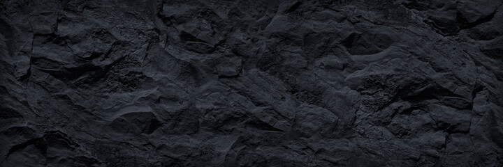 Black and white background. Abstract black background. Dark gray stone background. Black rock texture. Mountain surface. Close-up. Stone wall.