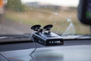 Radar detector in the car. Compliance with the speed limit on the car. - obrazy, fototapety, plakaty