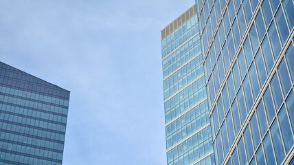 Bottom view of glass silhouette of skyscraper. Business building. Skyscraper with glass facade. Modern building in business district. Concepts of economics, financial, future.   