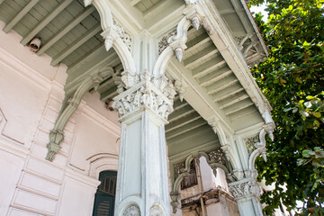 Carved wooden columns in Old Dispensary- ornate, storied, elegant late-19th-century building with elaborate Indian and European elements, now home to a museum, close-up, Stone Town, Zanzibar.