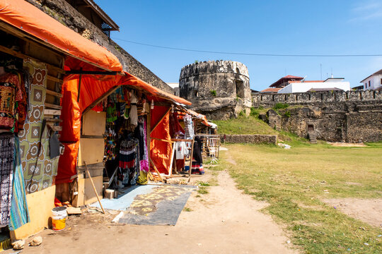 Courtyard of The Old Fort (Swahili: Ngome Kongwe), also known as the Arab Fort, with colorful souvenir tourist-oriented shops and remains of fortifications, Stone Town, Zanzibar.