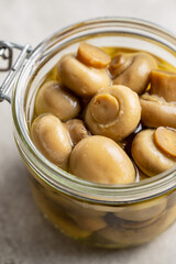 Pickled champignons. Marinated mushrooms in jar.