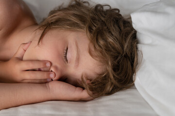 Adorable kids sleeping in bed at home. Healthy peaceful sleep.