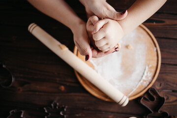 Fototapeta na wymiar Mother and daughter kneading gingerbread dough