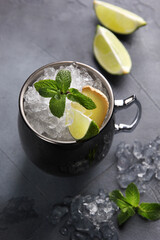 Alcoholic drinks. Mojito cocktail. Cocktail in a mug with lime, ice and mint on a light gray background. Vertical. Background image, copy space