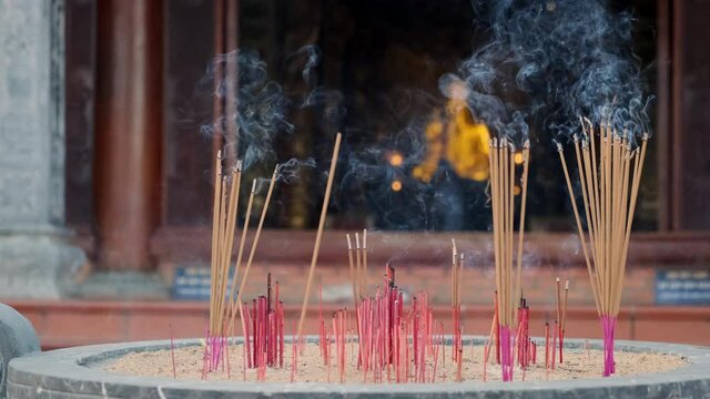 Scent of joss sticks spreading over Buddhist temple