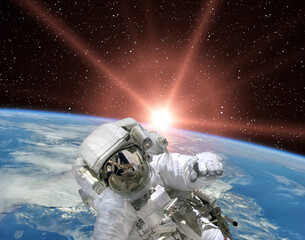 Astronaut and sunrise. The elements of this image furnished by NASA. © wowinside