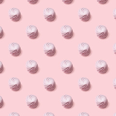 Seamless pattern of sweet pink marsh-mallows against pink backround.