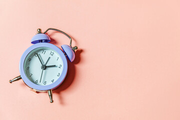 Simply minimal design ringing twin bell vintage classic alarm clock Isolated on pink pastel...