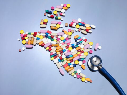Stethoscope with pills in shape of North America