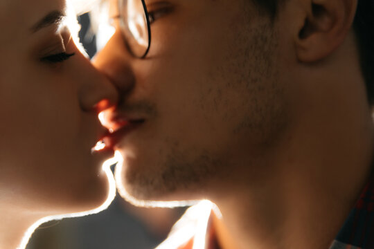 Close-up of a young romantic couple kissing and enjoying each other's company on the street