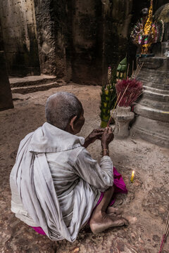Devotee nun, lighting incense and offering prayers at Preah Khan Temple, Angkor, Cambodia