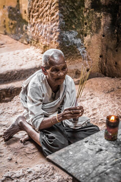 Devotee nun, lighting incense and offering prayers at Preah Khan Temple, Angkor, Cambodia