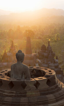 Buddha and morning mist, The Buddhist Temple of Borobudur, Java, Indonesia