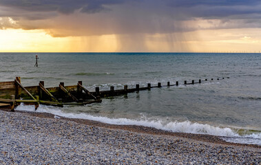 Fototapeta na wymiar Storm over the North Sea at sunset, captured from Sheringham beach