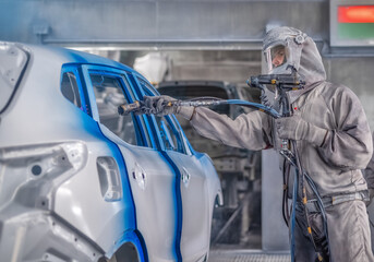 employee body painting workshop carries out painting of the internal elements of the car.