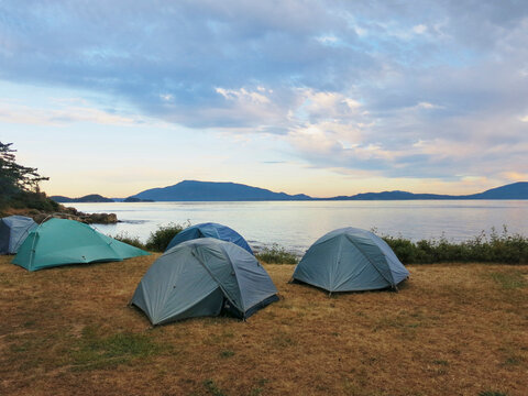 Tents on Patos Island campsite at dawn, San Juan Islands, Washington State, USA