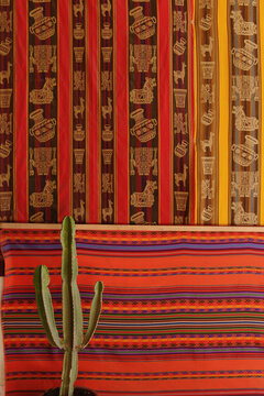 Cacti and display of peruvian textiles, Cusco, Peru, South America