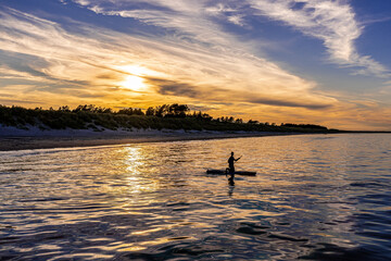 Silhouette of a canoeist in sunset on the beach in North Jutland, Denmark