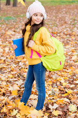 small child with happy face in headset hold books, study