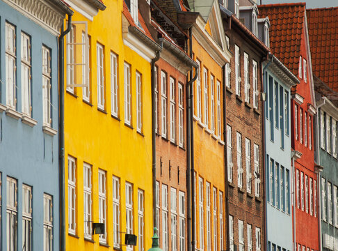 Row of multi colored traditional townhouses, Nyhavn harbor, Copenhagen, Denmark